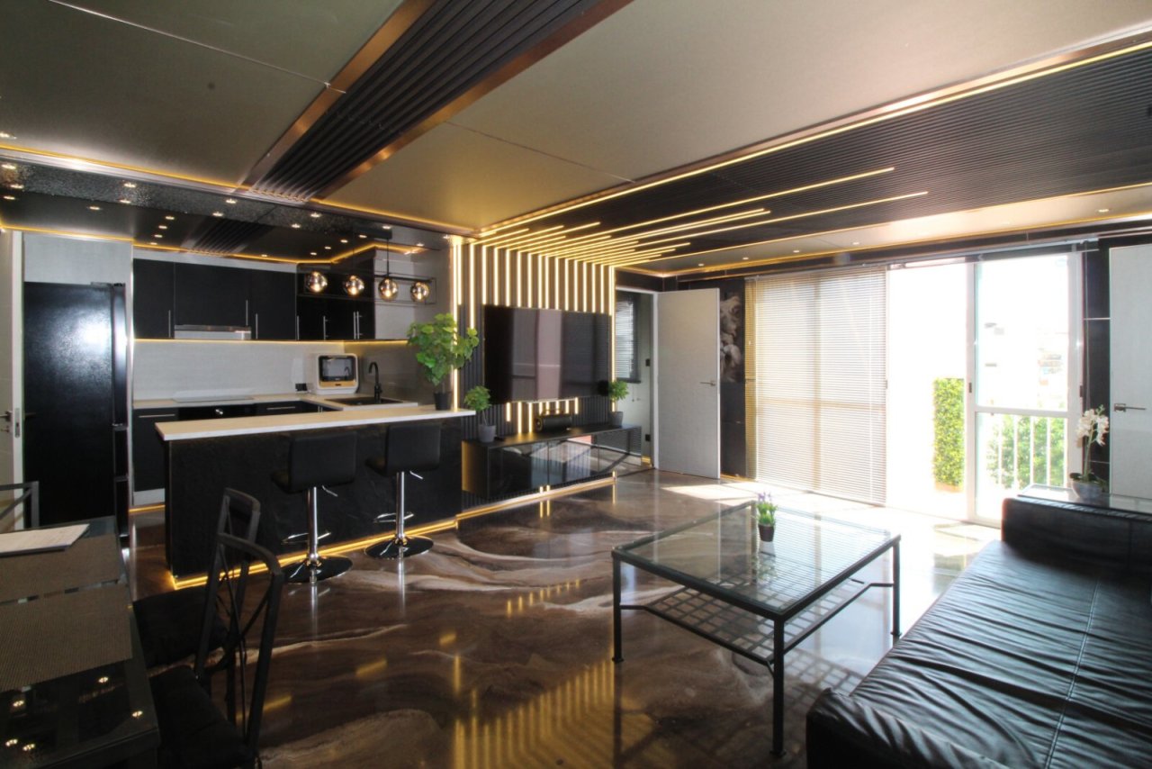 Open living and kitchen concept with high-quality furnishings and balcony access