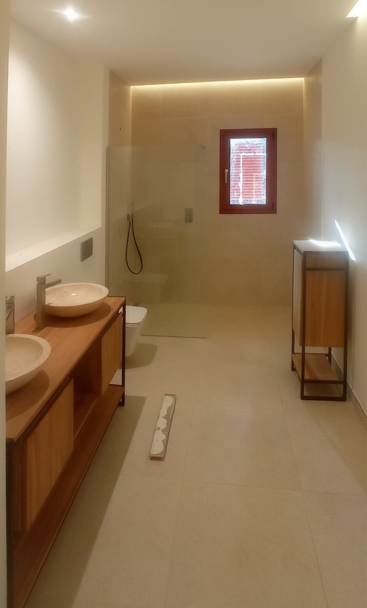 Modern bathroom with walk-in shower and large washbasin unit