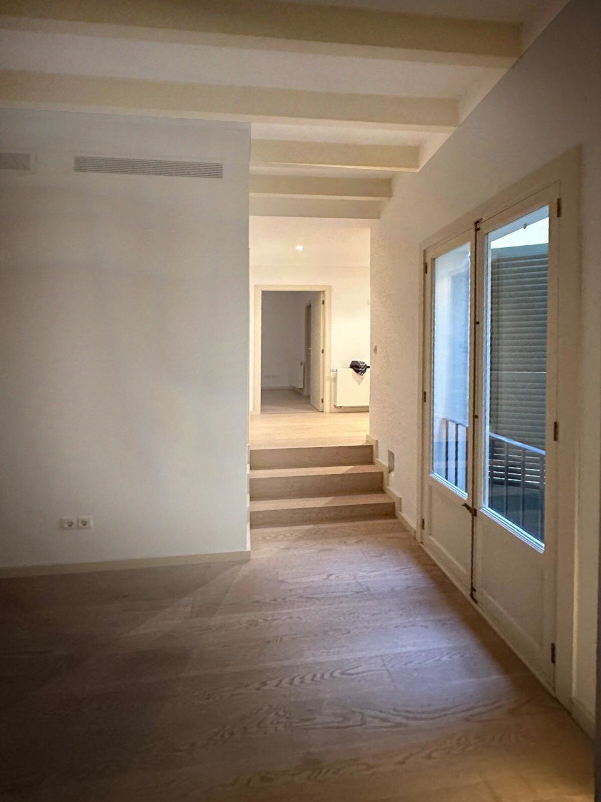 Elegant passage area with level adjustment and sophisticated ceiling architecture