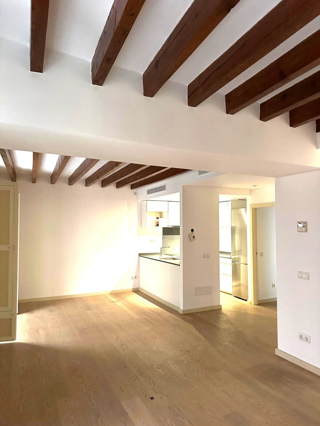 Characterful ceiling design with wooden beams and open floor plan