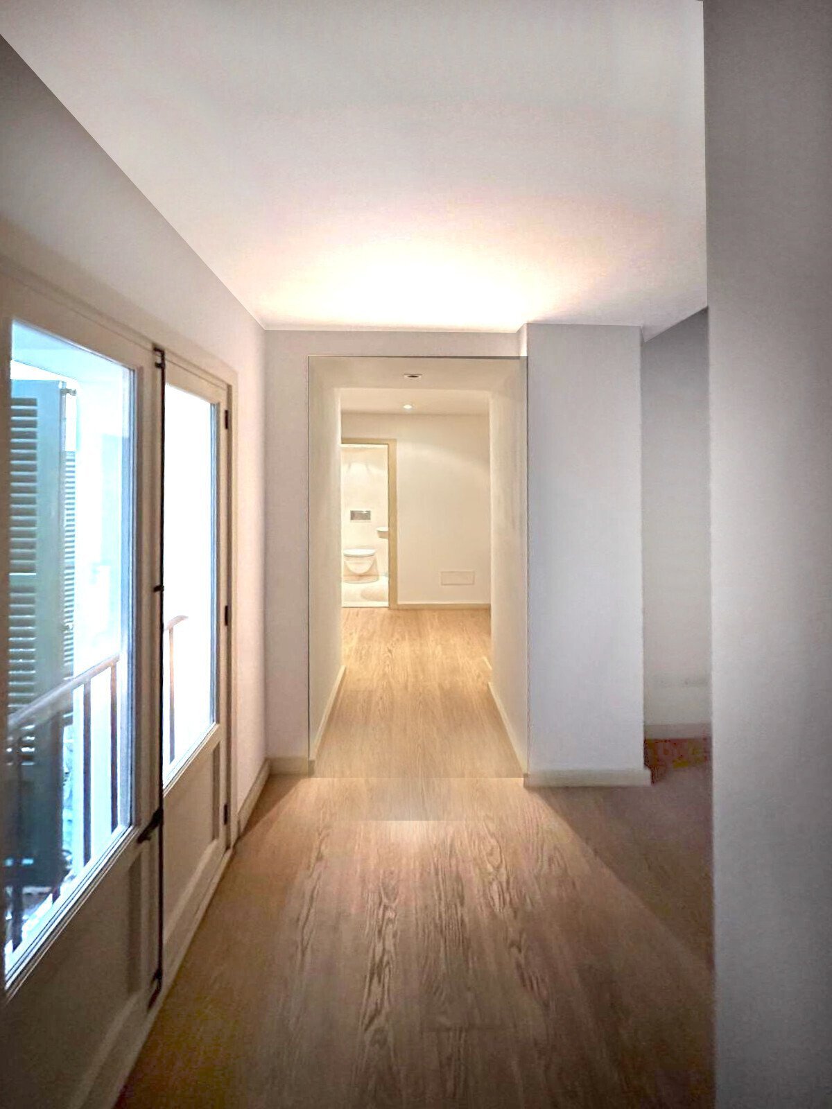 Bright corridor with optimal room depth and indirect LED ceiling lighting