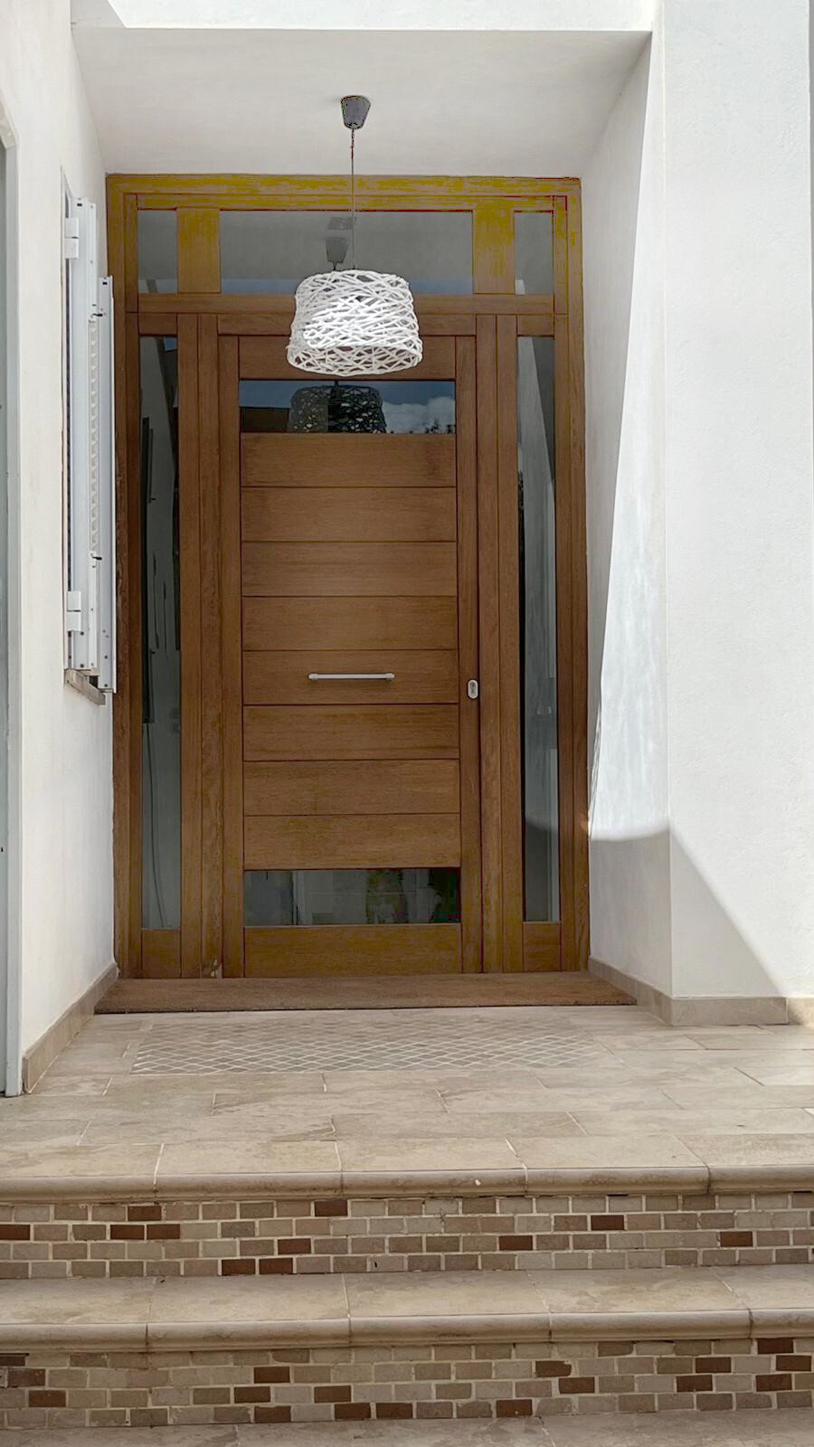 High-quality entrance door with side light openings and elegant transom glazing High-quality entrance door with side light openings and elegant transom glazing