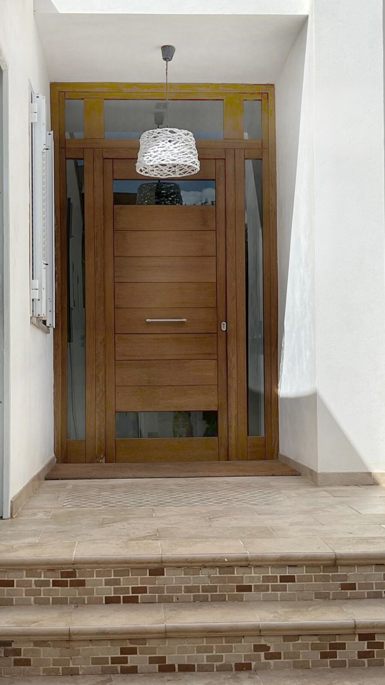 High-quality entrance door with side light openings and elegant transom glazing High-quality entrance door with side light openings and elegant transom glazing