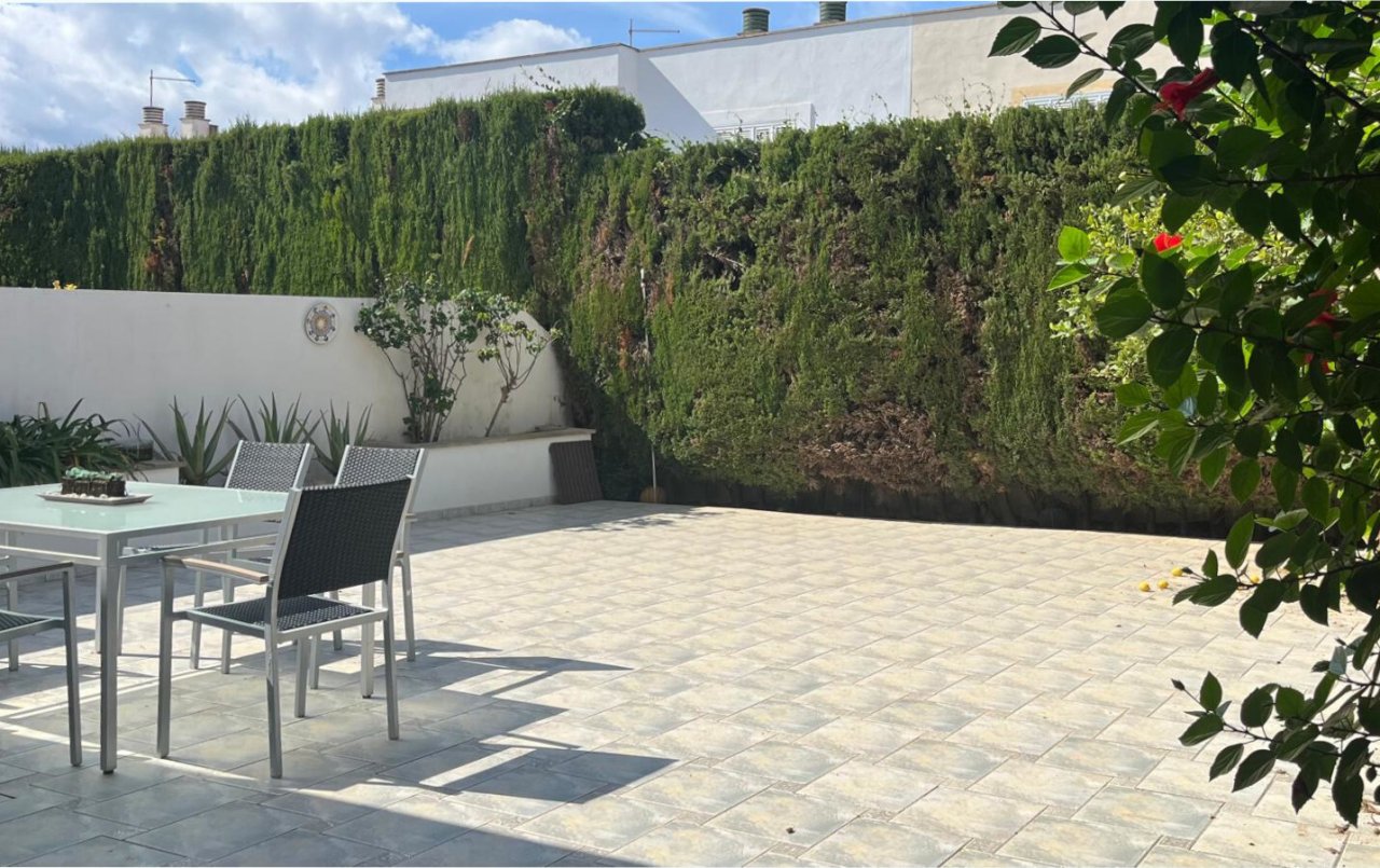 Terrace area with high-quality natural stone paving and a private garden ambiance Terrace area with high-quality natural stone paving and a private garden ambiance