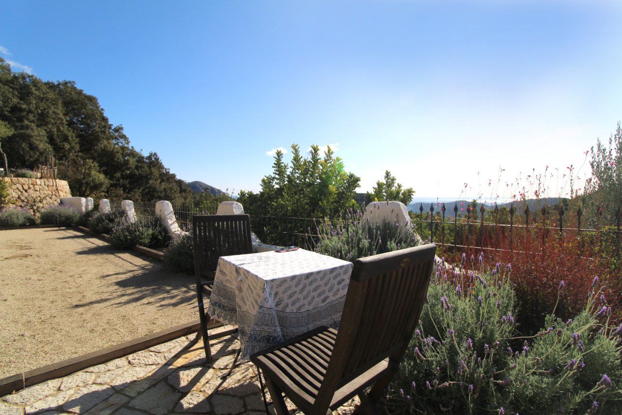 Terrace complex with natural stone walls, pergola roof, and picturesque valley panorama