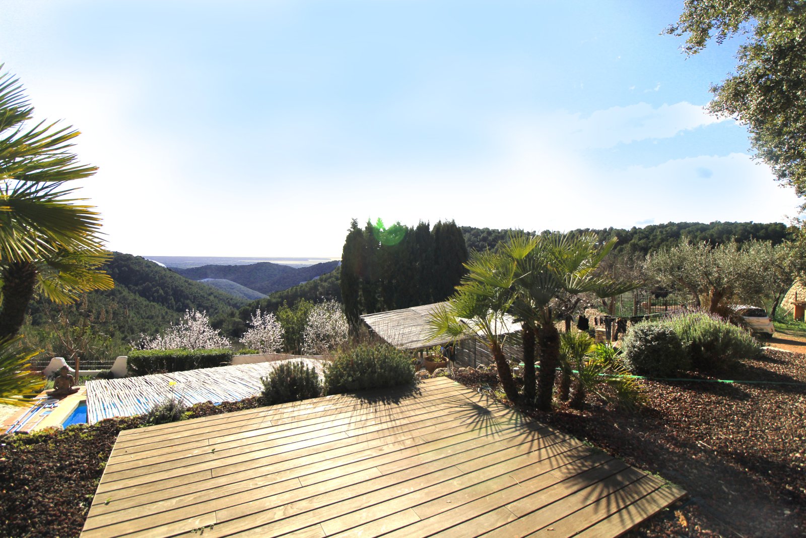 Terrace landscape with wooden decking, pergola structures, and spectacular valley panorama