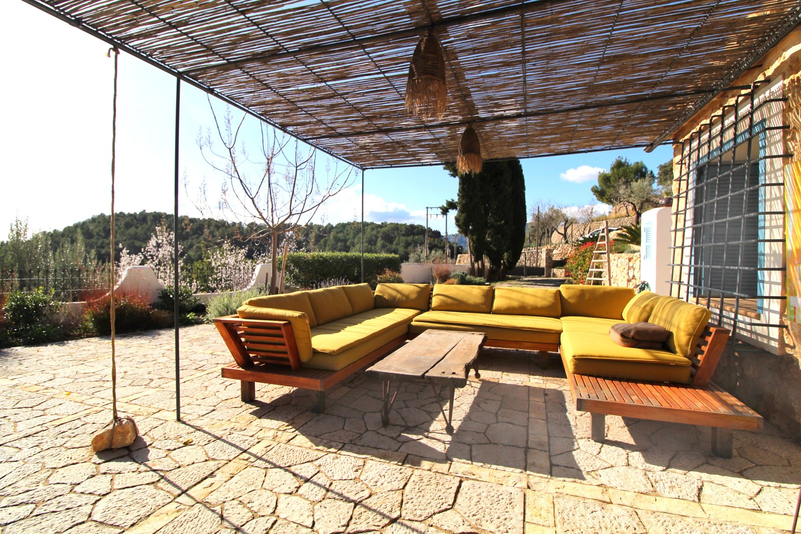 Terraced outdoor area with pergola and panoramic landscape view
