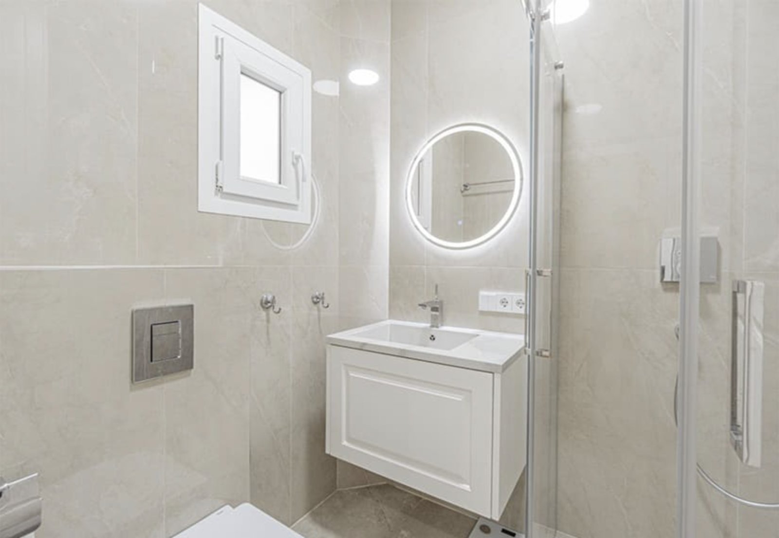 Modern bathroom with LED mirrors and walk-in shower