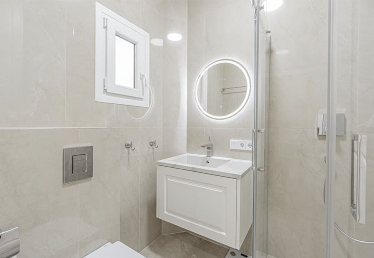 Modern bathroom with LED mirrors and walk-in shower