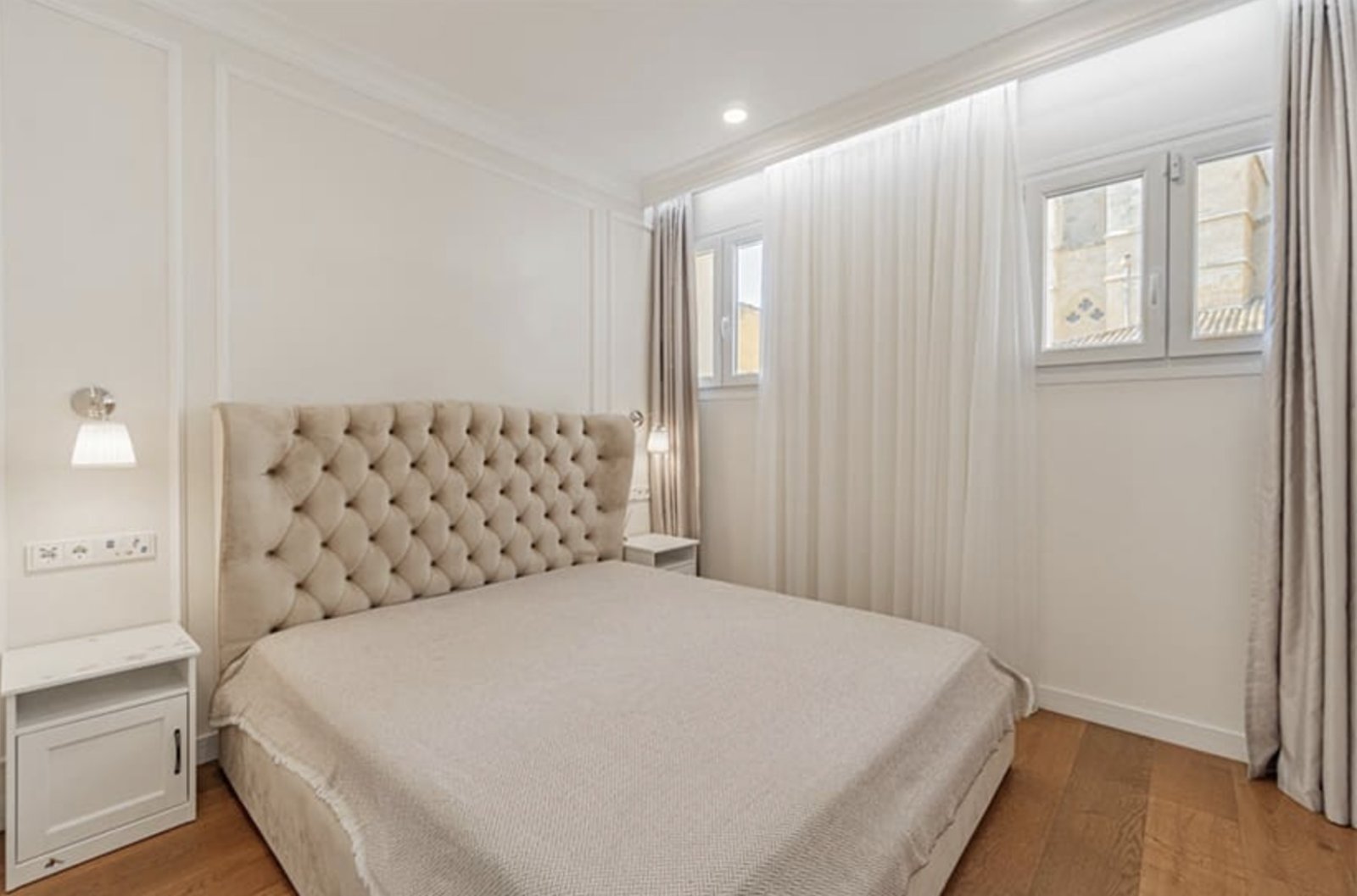 Bright bedroom with large windows and high-quality furnishings