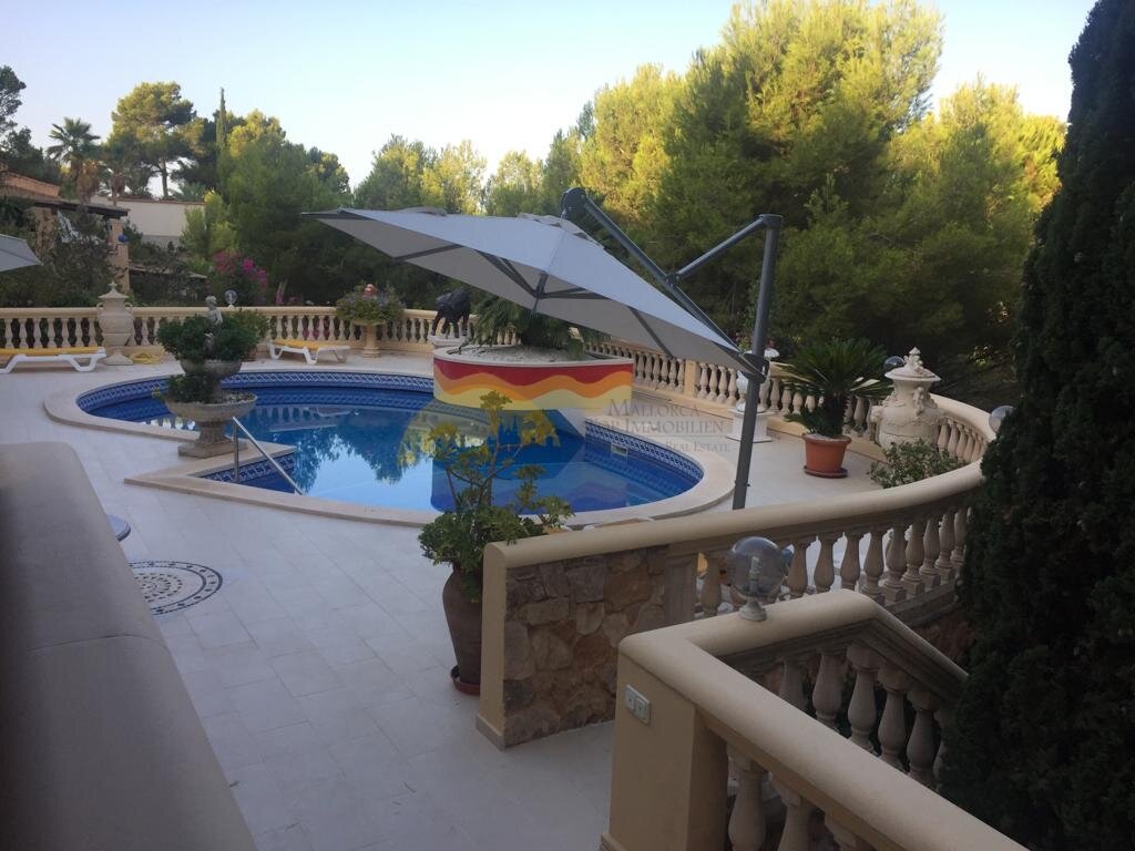 Pool area with professional shading solution and surrounding terrace
