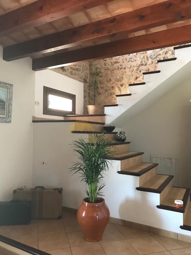 Modern staircase with storage and a distinctive stone wall Modern staircase with storage and a distinctive stone wall