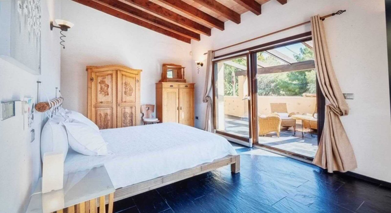 Main bedroom with a characterful wooden beam ceiling and direct terrace access Main bedroom with a characterful wooden beam ceiling and direct terrace access