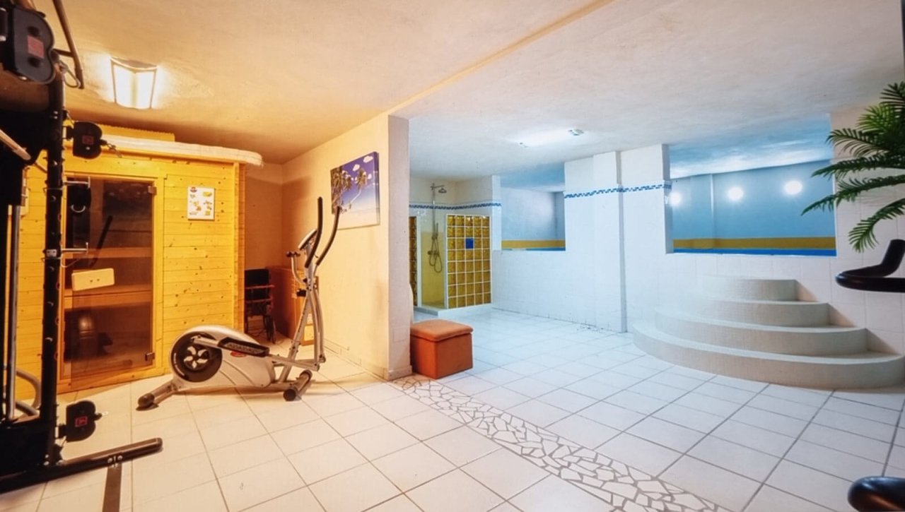 Wellness oasis with sauna, whirlpool, and professional fitness area Wellness oasis with sauna, whirlpool, and professional fitness area