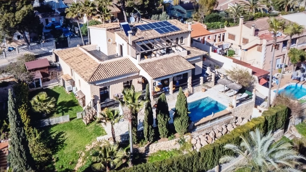 Aerial view: Modern villa with pool, solar system, and Mediterranean-style property Aerial view: Modern villa with pool, solar system, and Mediterranean-style property
