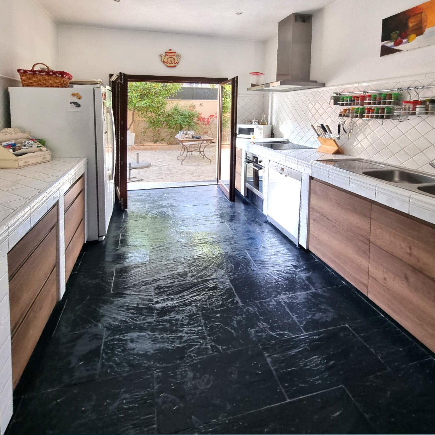 Modern kitchen with direct terrace access and high-quality built-in appliances Modern kitchen with direct terrace access and high-quality built-in appliances