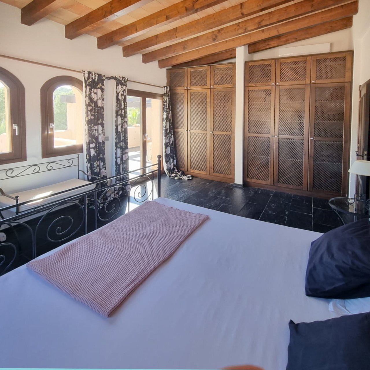 Main bedroom with wooden beam ceiling, dressing area, and access to the terrace Main bedroom with wooden beam ceiling, dressing area, and access to the terrace
