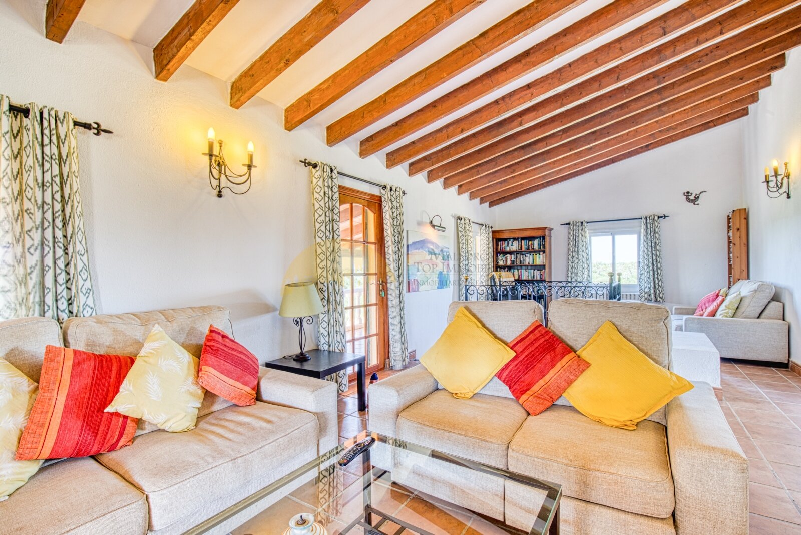 Living area with impressive wooden beam ceiling and harmonious room layout Living area with impressive wooden beam ceiling and harmonious room layout