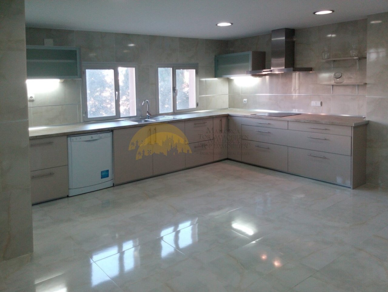 Modern kitchen with large glass surfaces and high-quality furnishings
