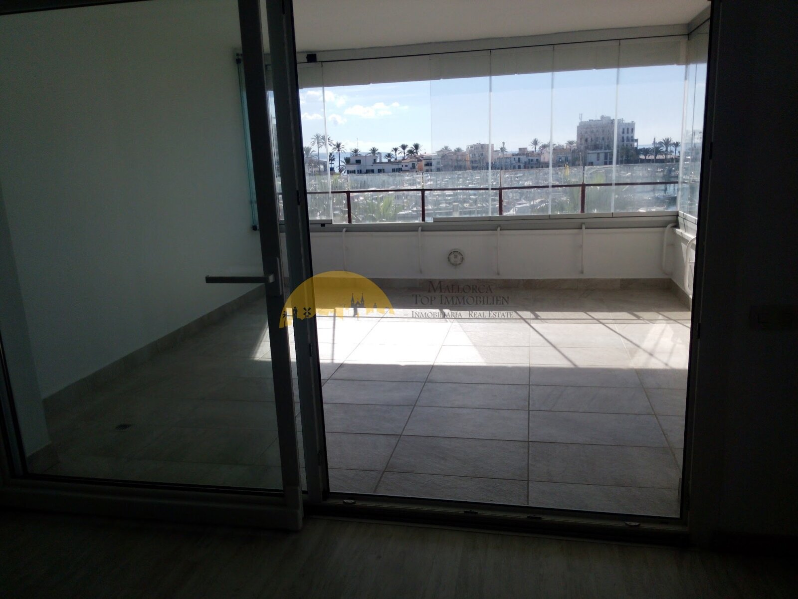 Sun-drenched terrace with unobstructed harbor view and panoramic glazing