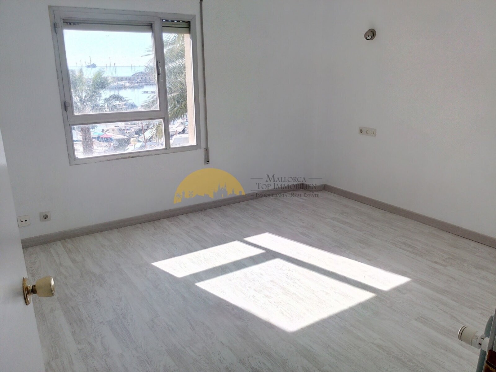 Bright bedroom with large windows and harbor view