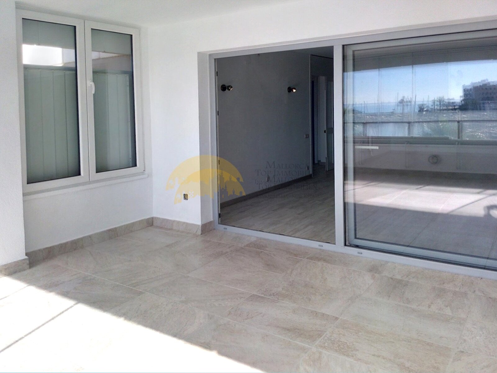 Modern bedroom with floor-to-ceiling window, walk-in closet, and direct terrace access