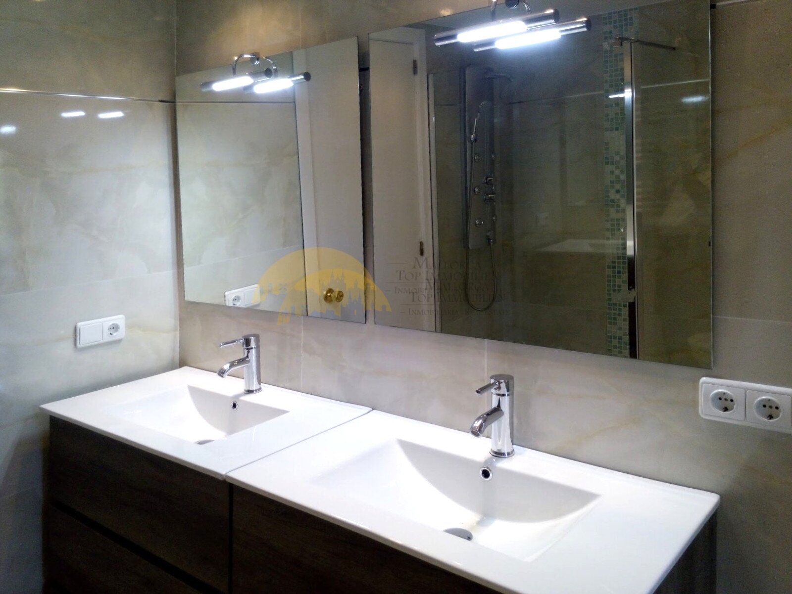 Modern double washbasin bathroom with large mirror front and integrated shower system