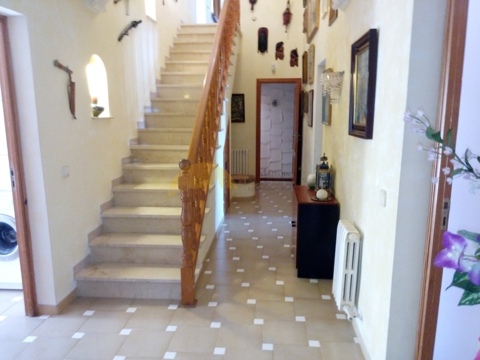Representative entrance area with an elegant staircase and functional layout