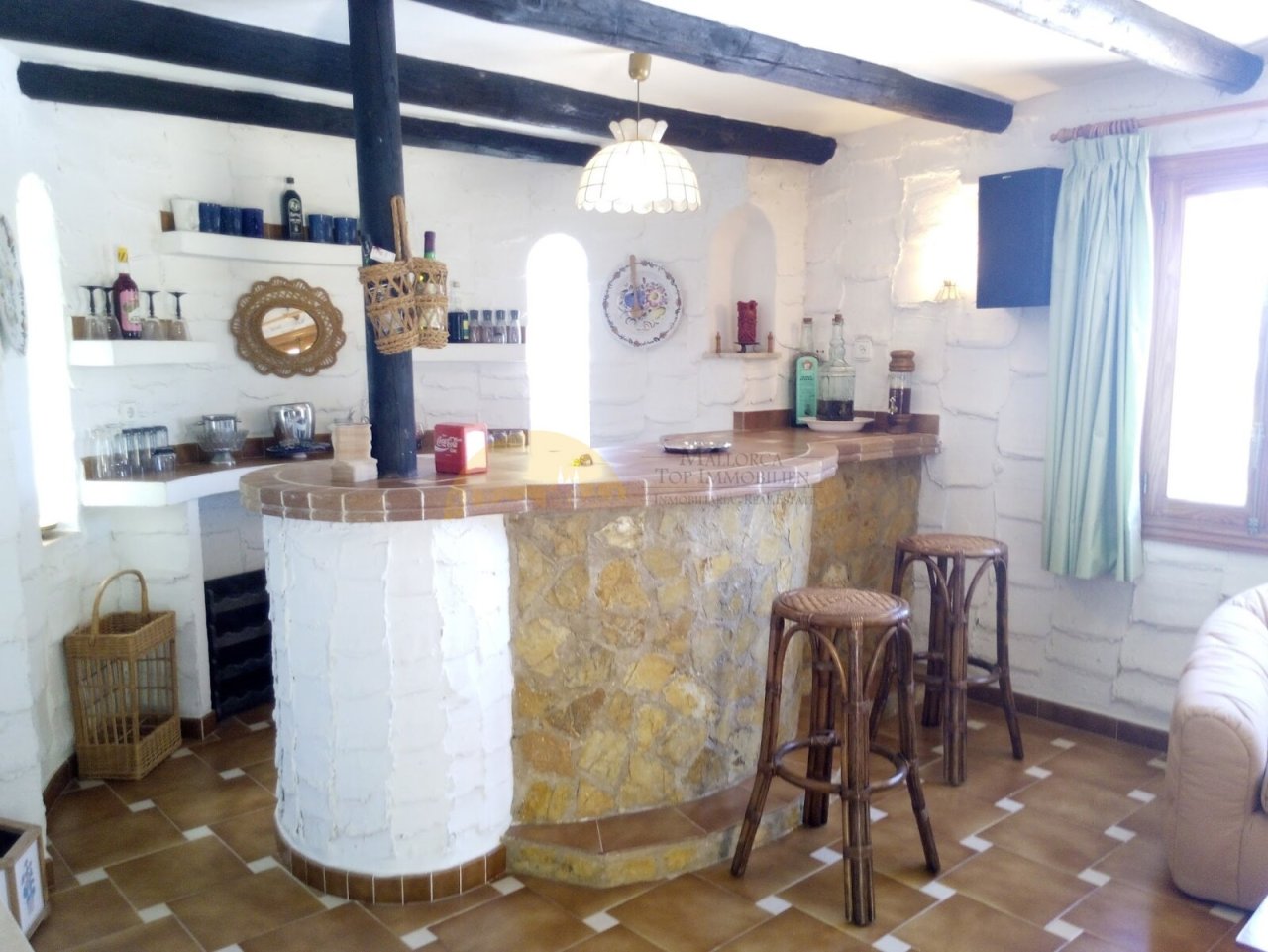 Open bar counter with distinctive ceiling beams and integrated bar equipment