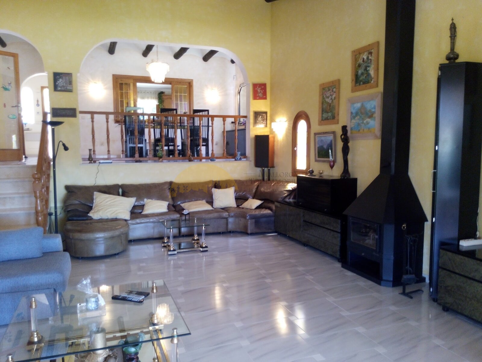 Living area with fireplace, gallery, and open connection to the upper floor