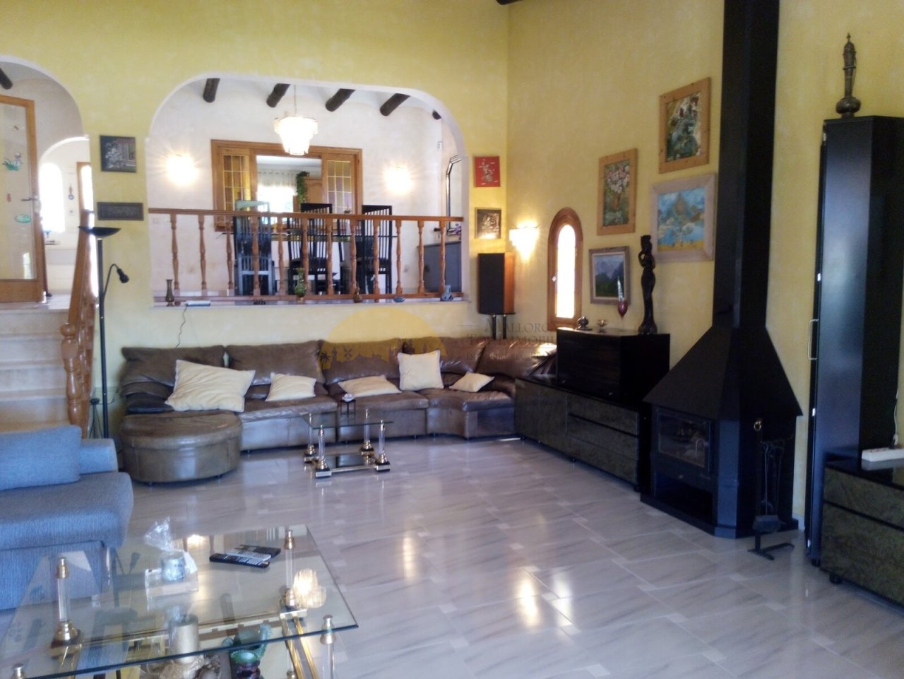 Living area with fireplace, gallery, and open connection to the upper floor