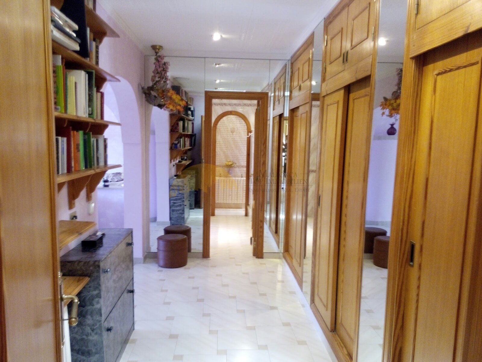 Functional corridor with extensive built-in wardrobe and direct access to all living areas