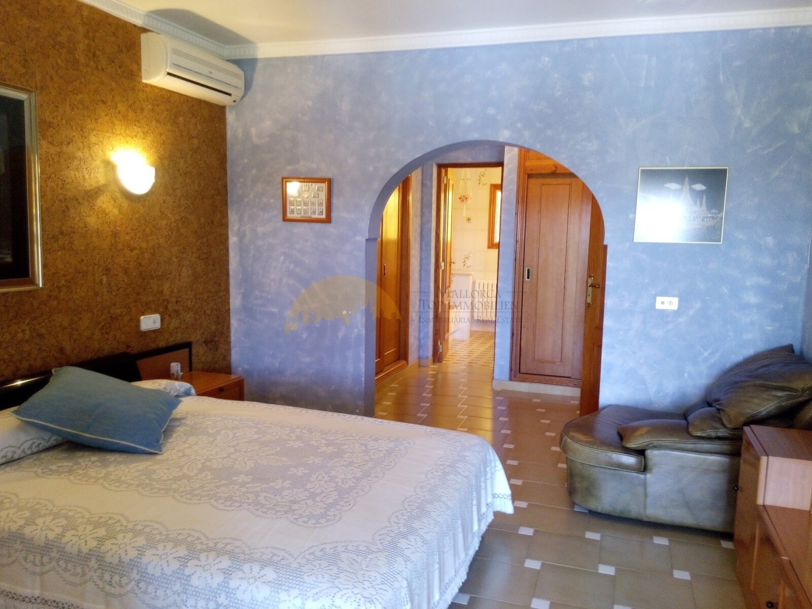 Comfortable bedroom with elegant archways and practical layout