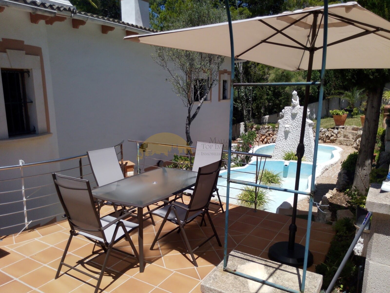 Covered terrace with shade awning and direct pool access