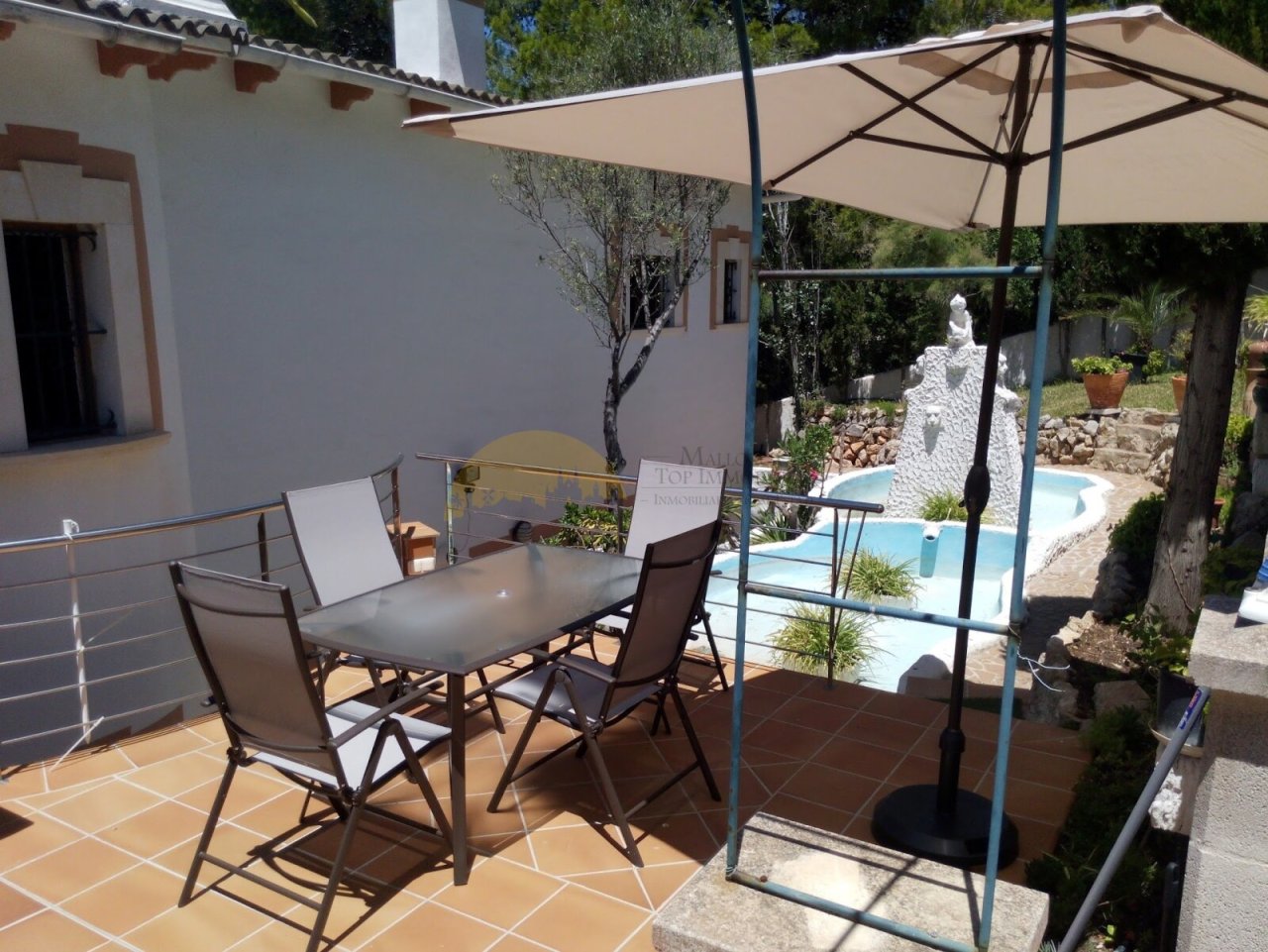 Covered terrace with shade awning and direct pool access