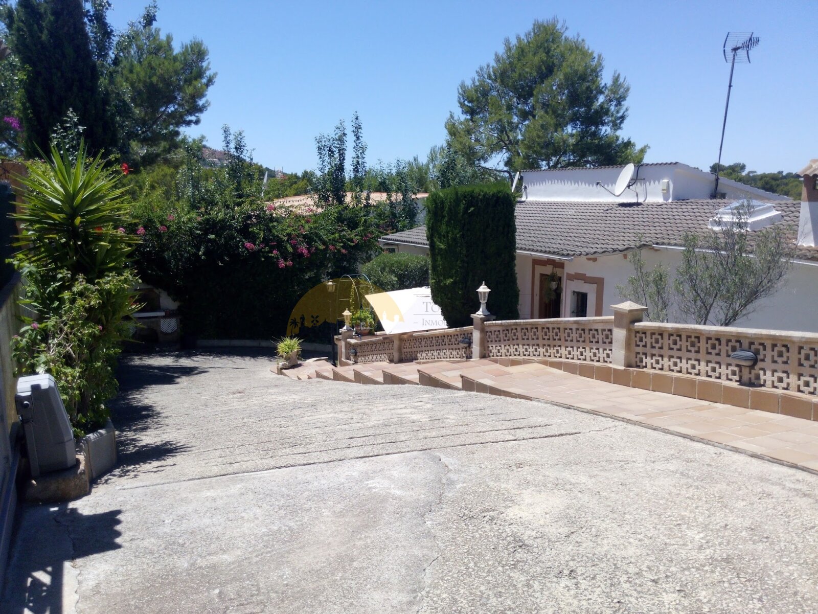 Spacious outdoor area with an elegant terrace and structured pathways