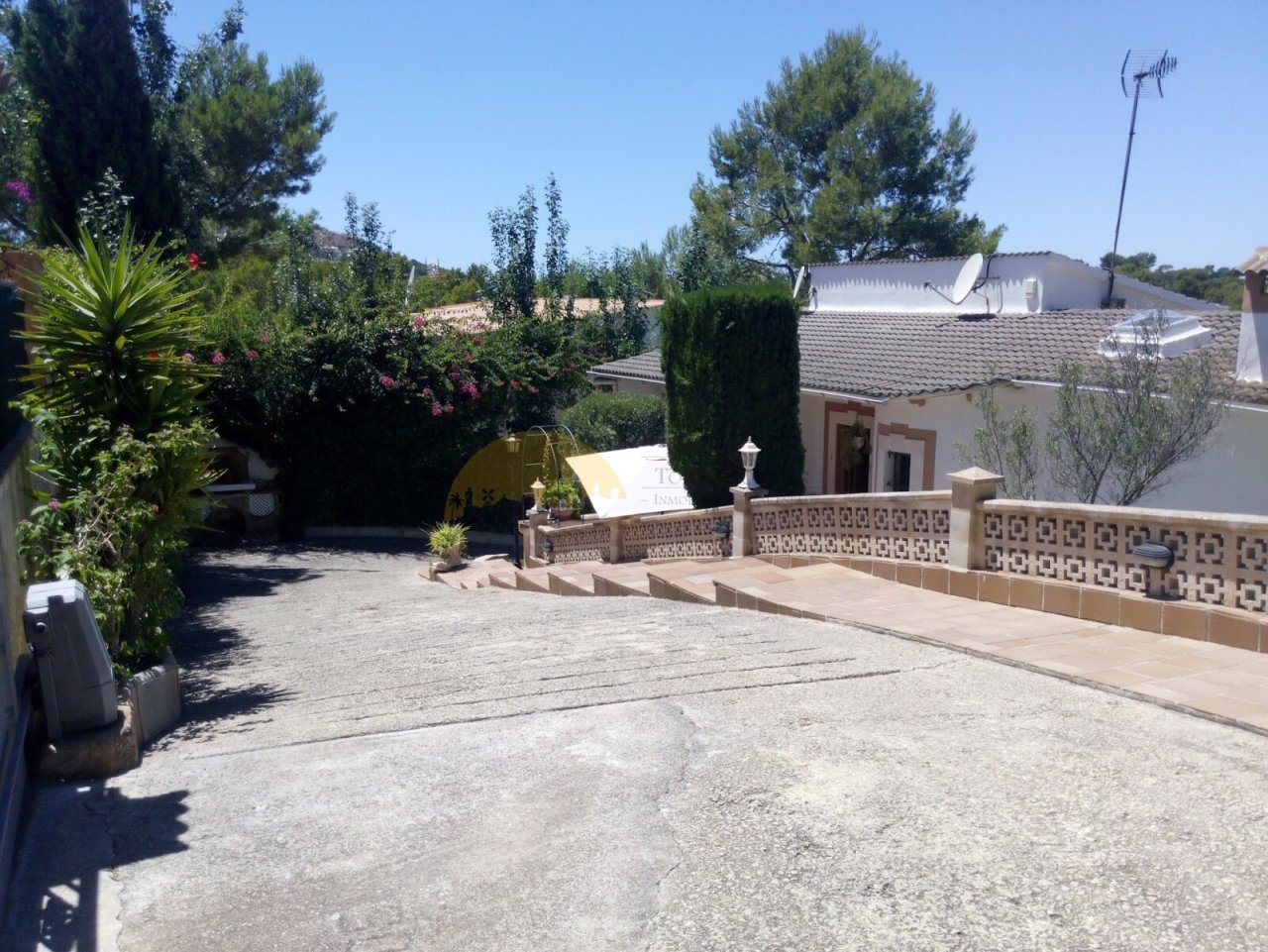 Spacious outdoor area with an elegant terrace and structured pathways