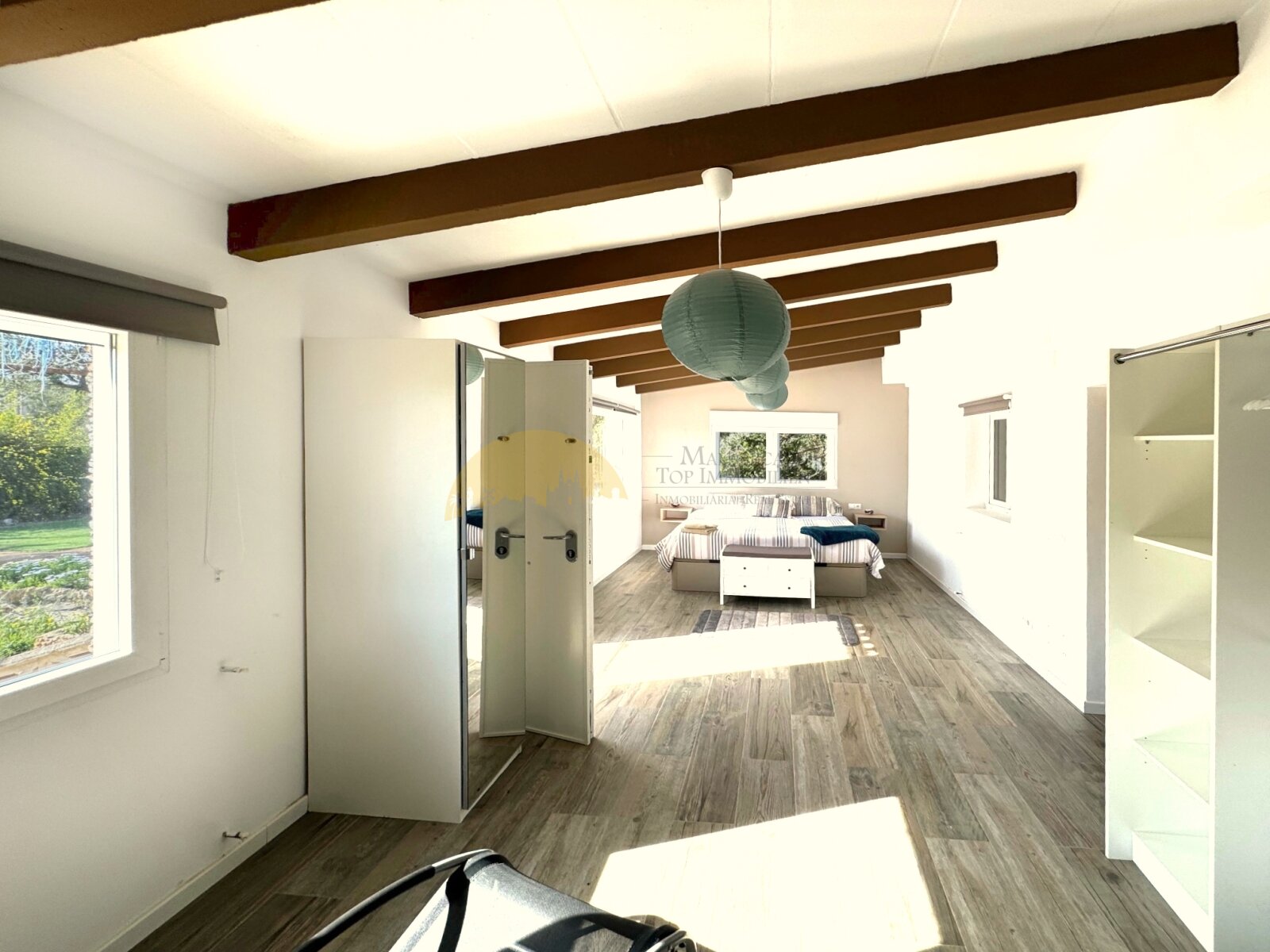 Elegant bedroom with a characterful beamed ceiling and smart layout for optimal living