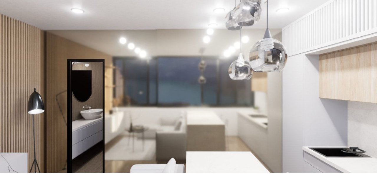 Zona de estar abierta con zona de cocina integrada y diseño elegante de lámparas colgantes
