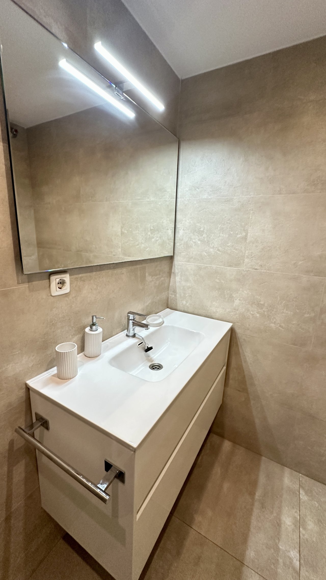 Baño moderno para huéspedes con luces LED en el espejo y equipamiento sanitario de alta calidad Baño moderno para huéspedes con luces LED en el espejo y equipamiento sanitario de alta calidad