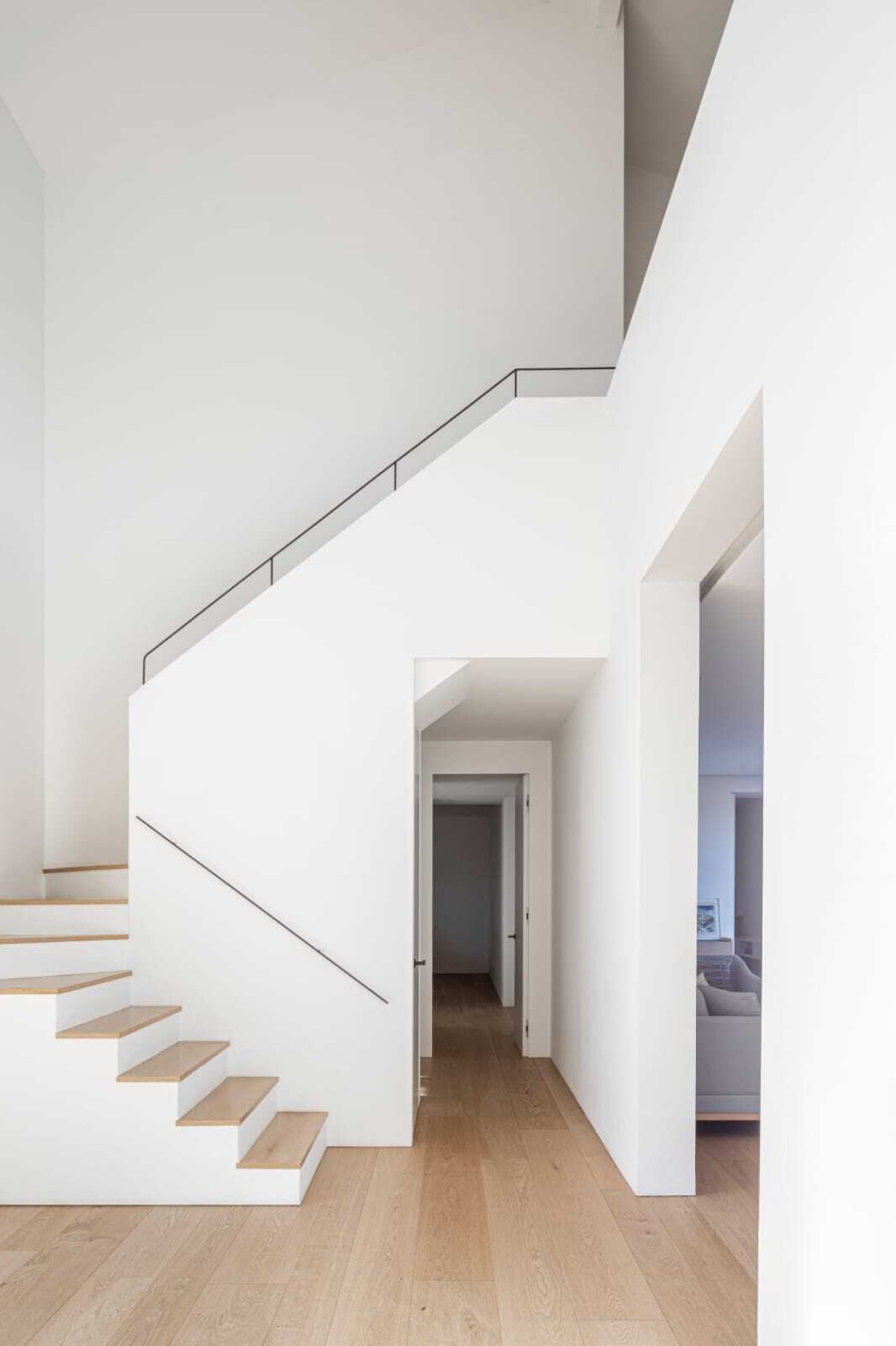Vestíbulo elegante con escaleras con transiciones fluidas y un concepto de espacio bien pensado Vestíbulo elegante con escaleras con transiciones fluidas y un concepto de espacio bien pensado