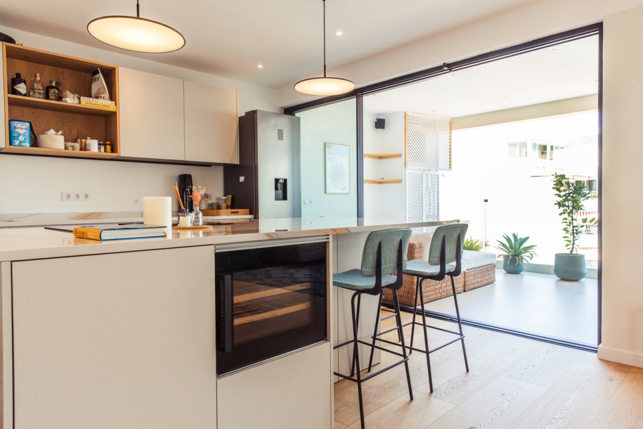 Cocina moderna con isla central y almacenamiento integrado, perfecta para vivir en concepto abierto.