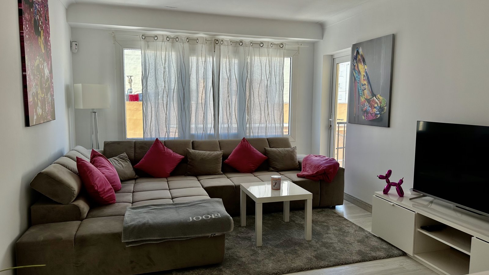 Salón luminoso con gran ventanal y acceso directo al balcón