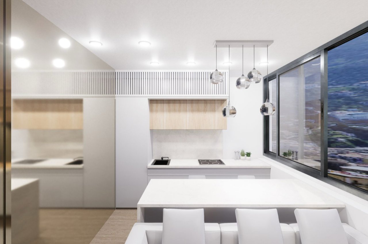 Cocina moderna con zona de cocción integrada y ventanas panorámicas de piso a techo Cocina moderna con zona de cocción integrada y ventanas panorámicas de piso a techo