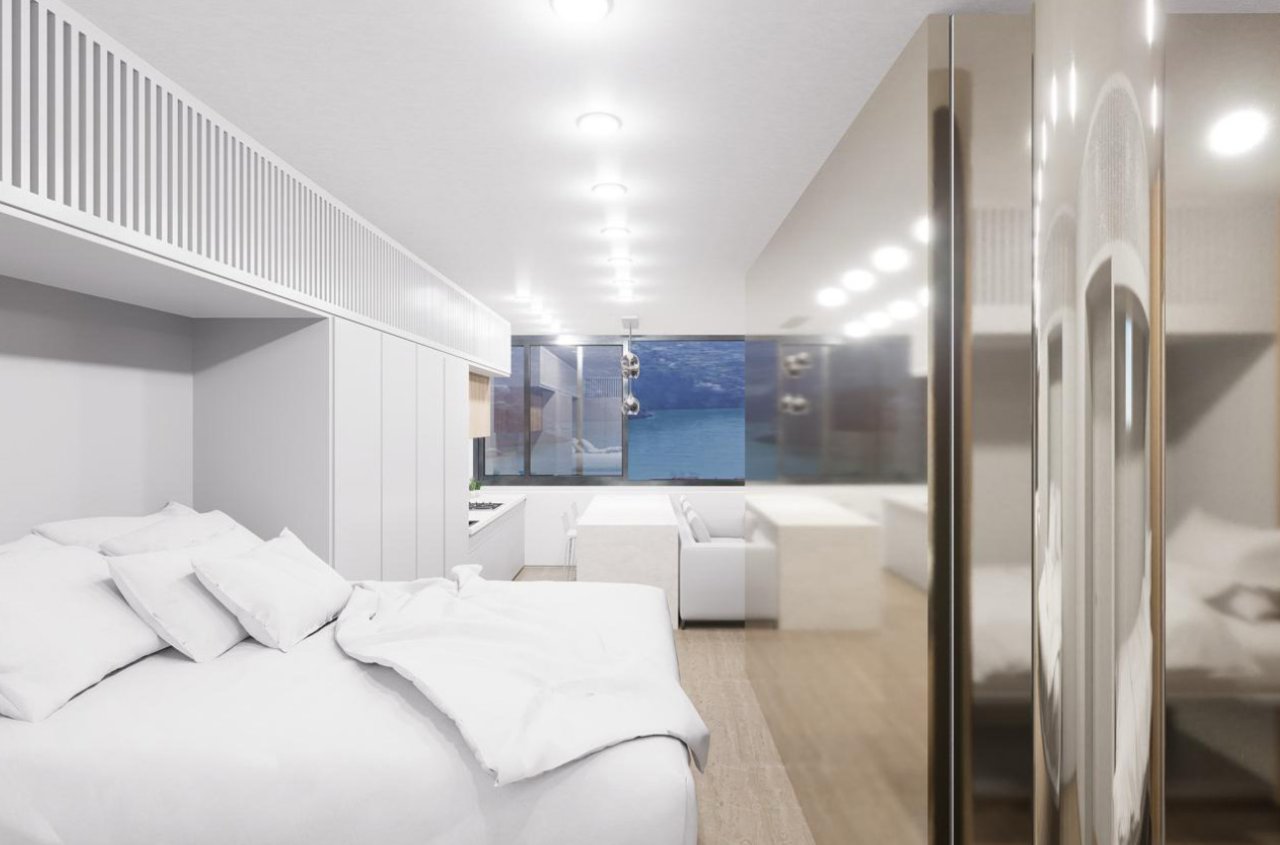 Área de dormir con vestidor integrado y elementos de espejo de piso a techo Área de dormir con vestidor integrado y elementos de espejo de piso a techo