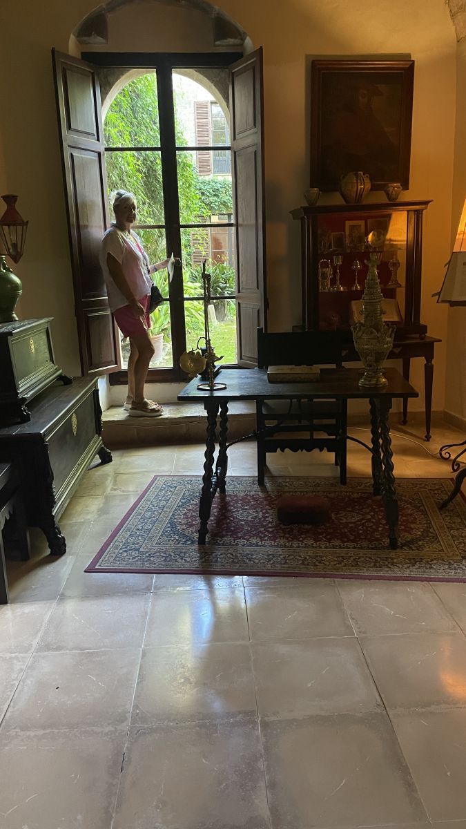 Claudia am Fenster in einem Raum des Herrenhauses Els Calderers auf Mallorca.
