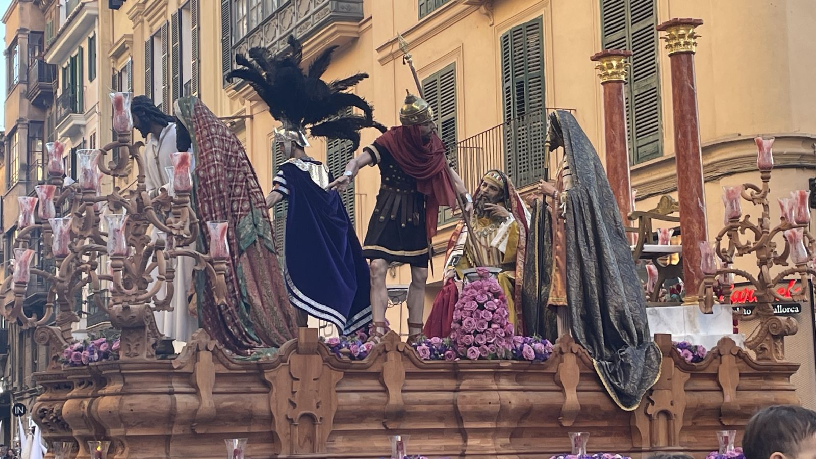 Nazarenos carrying a wooden cross during Holy Week in Mallorca